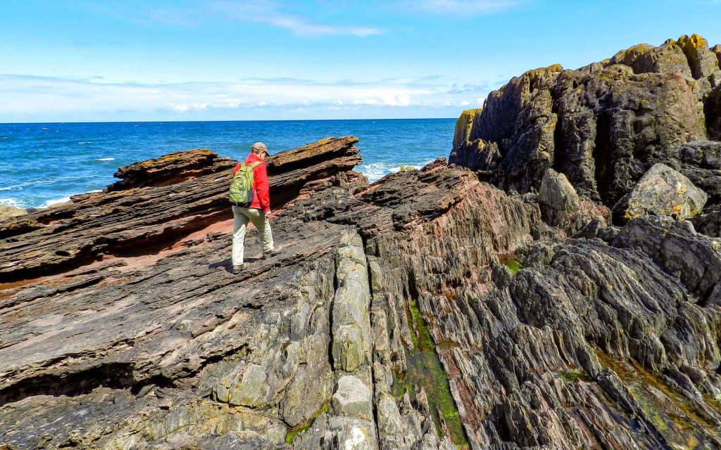 Hutton’s Unconformity at Siccar Point with a geotourist for scale