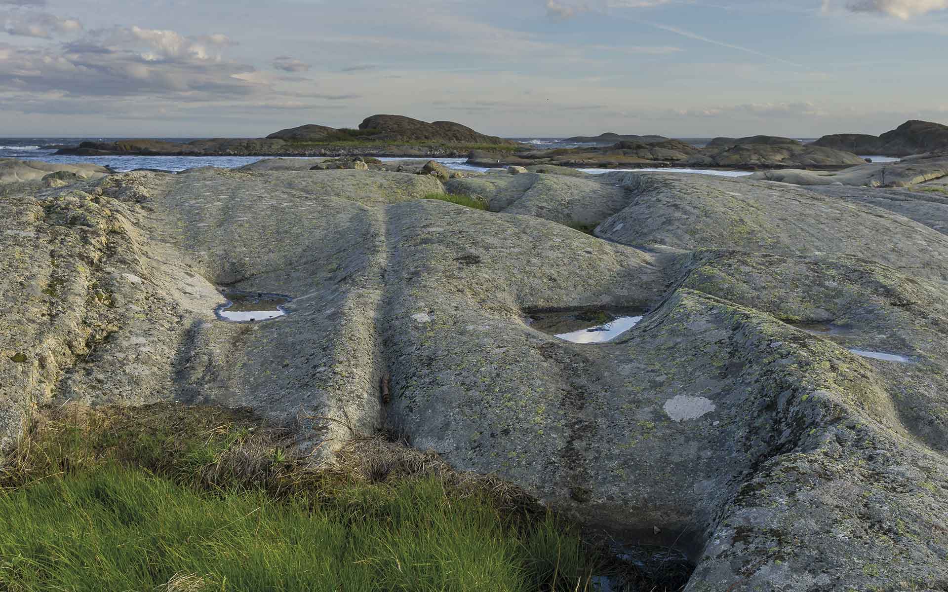 The larvikite landscape along the coast of Larvik. The rocks showing wonderful glacial features and a pegmatite to the left.