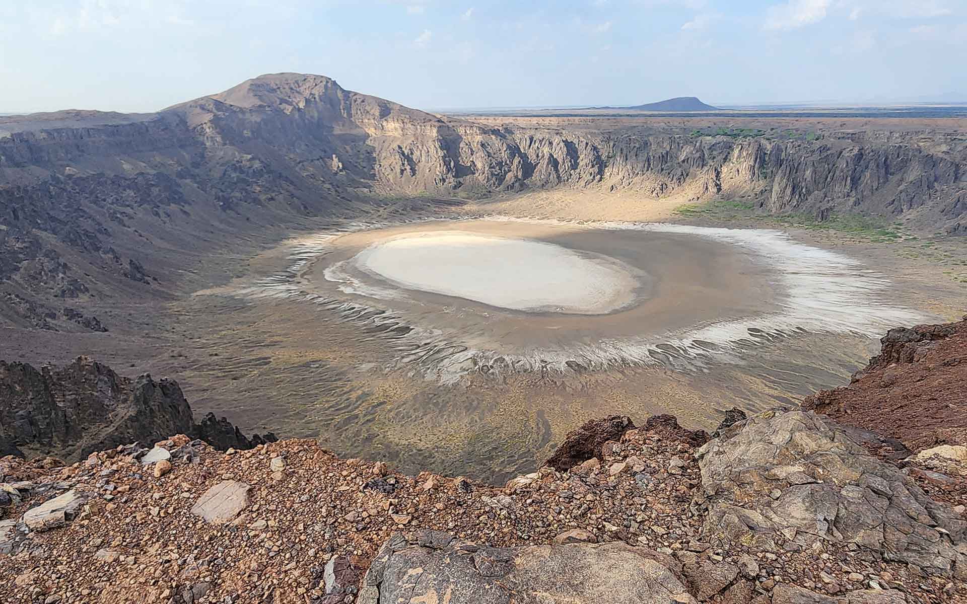 View of Al Wahbah maar cut deeply into the Neoproterozoic basement and pre-existing Pleistocene scoria cones and lava flows.