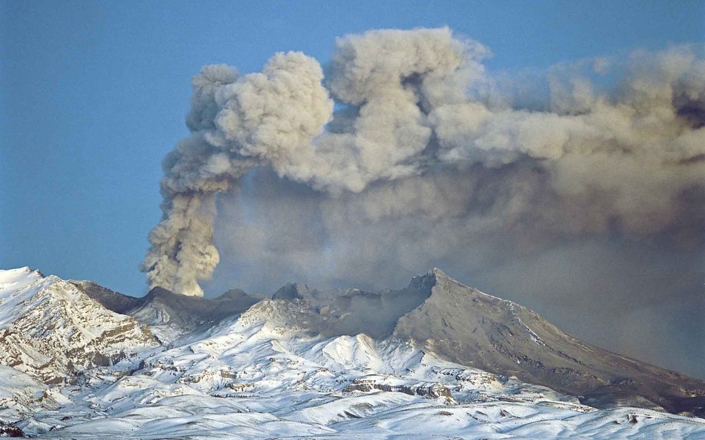Ruapehu Volcano and edifice looking to the west with the 1996 eruption, plume and ash fall (Photo, L Homer, 1996). Image GNS Science.